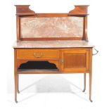 An Edwardian mahogany and marble top washstand Having a raised marble panel back above a