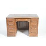 An early 20th Century oak twin pedestal desk Having a rectangular top with rounded corners raised