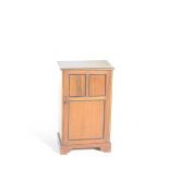 An Edwardian mahogany music cabinet The rectangular moulded top with an ebonised border over a