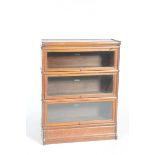 An early 20th Century oak Globe Wernicke bookcase Having three glazed tiers upon a plinth base,