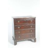 An early 19th Century mahogany secretaire chest With a rectangular moulded top above a sliding