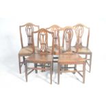 A harlequin set of six late 18th Century oak country chairs Each with an arched top rail above a