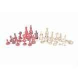 A carved bone chess set, early 20th century Coloured in red and white.