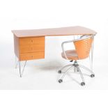 A contemporary cherry wood office desk and chair The desk with a shaped tapering angular top and