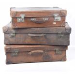 A graduated set of three tan leather suitcases,