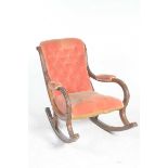 A Victorian walnut and upholstered rocking chair With a velour padded button back above channelled