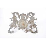 An early 19th Century gilt metal wall mounted Armorial Crest The central circular shield flanked by