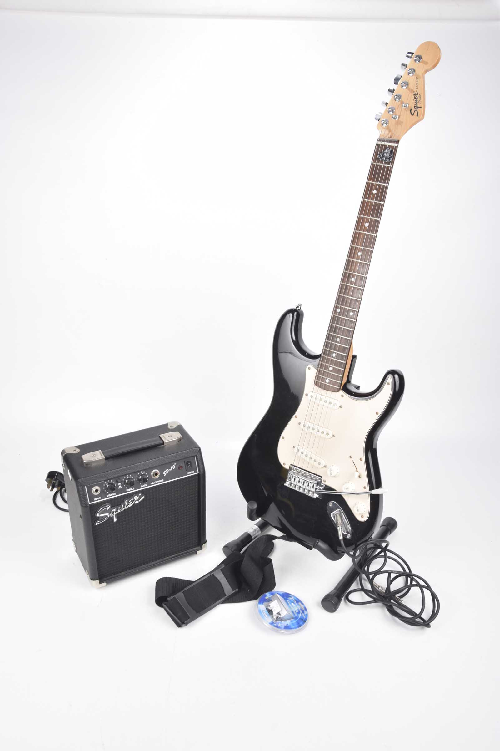 A Squire Fender Strat copy electric guitar late 20th Century Black and cream bodied guitar with