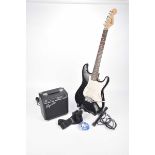 A Squire Fender Strat copy electric guitar late 20th Century Black and cream bodied guitar with