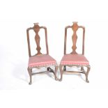 A pair of 18th/19th Century Dutch walnut low seat chairs Each chair with a paper scroll crest above