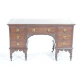 A Victorian mahogany knee-hole desk/dressing table With a rectangular moulded top above an