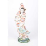 A Japanese figure of Guanyin (Kwannon) Modelled in standing position, wearing robes,