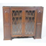 A 19th Century oak breakfront bookcase With a plain frieze above a central pair of astragal glazed