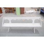 A 19th Century painted pine garden bench The shaped back rail supported on angled uprights above a