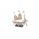 A Chinese white metal figure of a masted ship The traditional ship,