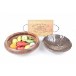 A large wooden bowl with painted paper mache fruit,