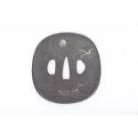 An ironwork Japanese Edo period Tsuba (sword guard) Of circular form with mixed metal overlay