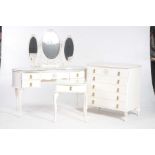 A white French style three piece bedroom suite Comprising a kidney shaped dressing table fitted