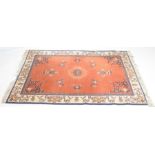 A Chinese silk style rug The central salmon pink coloured ground detailed with shou symbol and