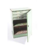 A Victorian painted pine cupboard The single panelled door enclosing three narrow drawers and a