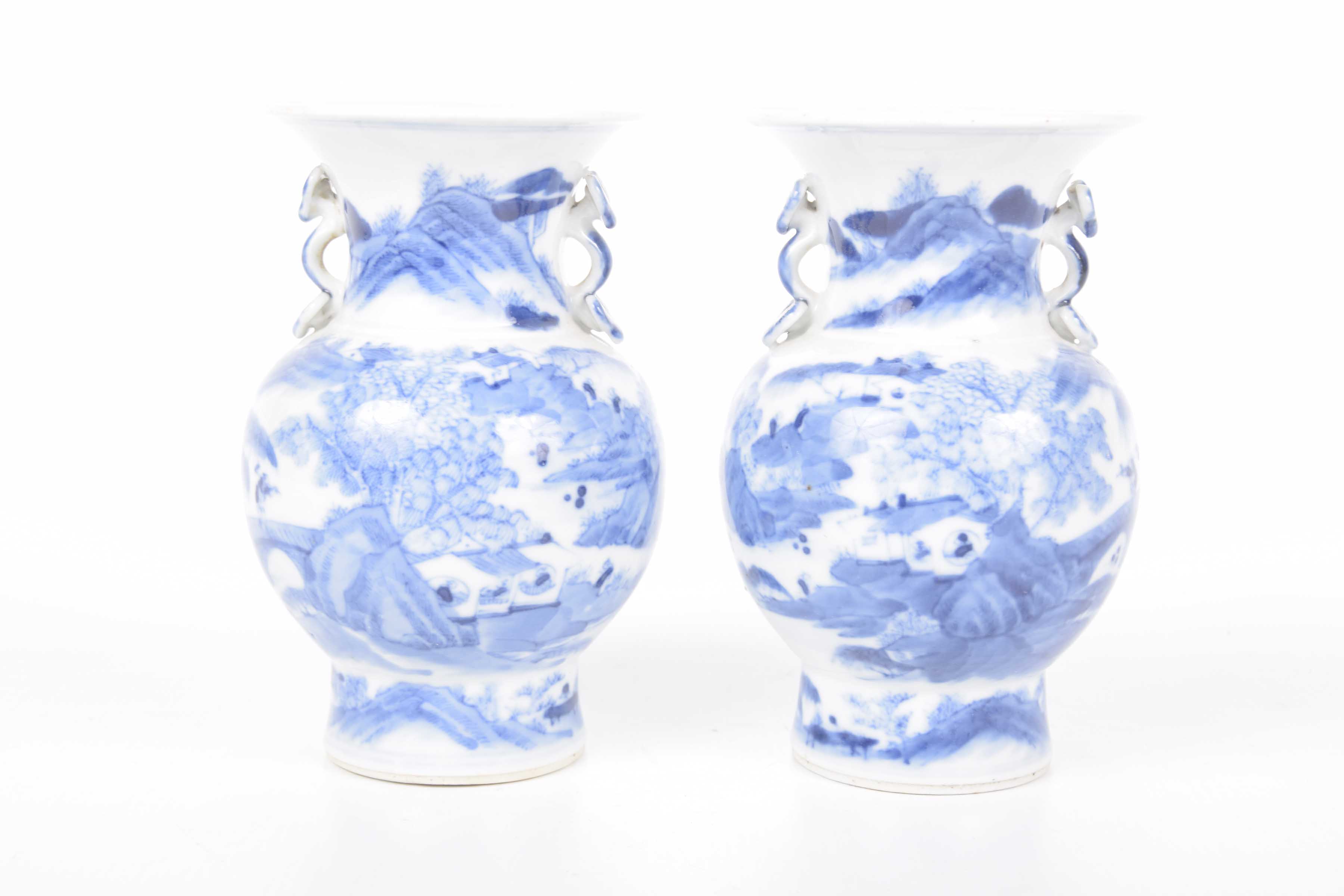 A pair of Chinese blue and white vases, Kangxi (1654-1722) Each of baluster form,