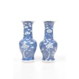 A pair of Chinese blue and white 'Prunus' yen-yen vases, Kangxi four character mark,