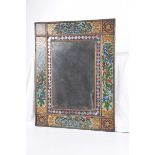 A Northern Indian style reverse painted glass mirror The plain mirror plate,