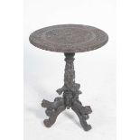 A heavily carved Indian hard wood occasional table, possibly Bombay,