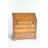 A good George III oak bureau The rectangular moulded fall front centred with an inlaid star