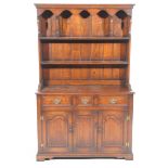 A good quality reproduction Georgian style oak dresser by Connoisseur The raised back with two