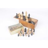 A carved wood chess set/early to mid 20th century Housed in a wooden box,