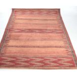 A contemporary geometric design rug The orange and red ground rug with a series of panelled inset