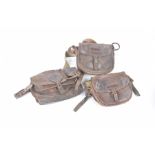 Three leather cartridge bags Each bearing the initials of their previous owner,