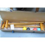 A boxed croquet set To include four mallets, hoops and various balls.