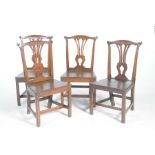 A set of four 18th Century oak country Chippendale style dining chairs Each chair with a cupids