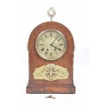 A late 19th Century French mantle clock The domed architectural case inlaid with various wood