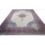 A Tabriz style carpet The large carpet with central ivory coloured reserve filled with flowerheads