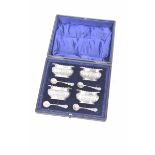 A cased set of four hallmarked silver salts Each with a gadroon border and embossed decoration