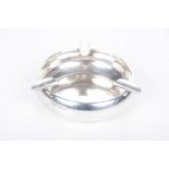 A hallmarked silver circular ashtray The circular bowl applied with three cigarette rests, 2.69ozs.
