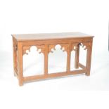 A Victorian ecclesiastical pitch pine side or altar table The rectangular moulded three plank top