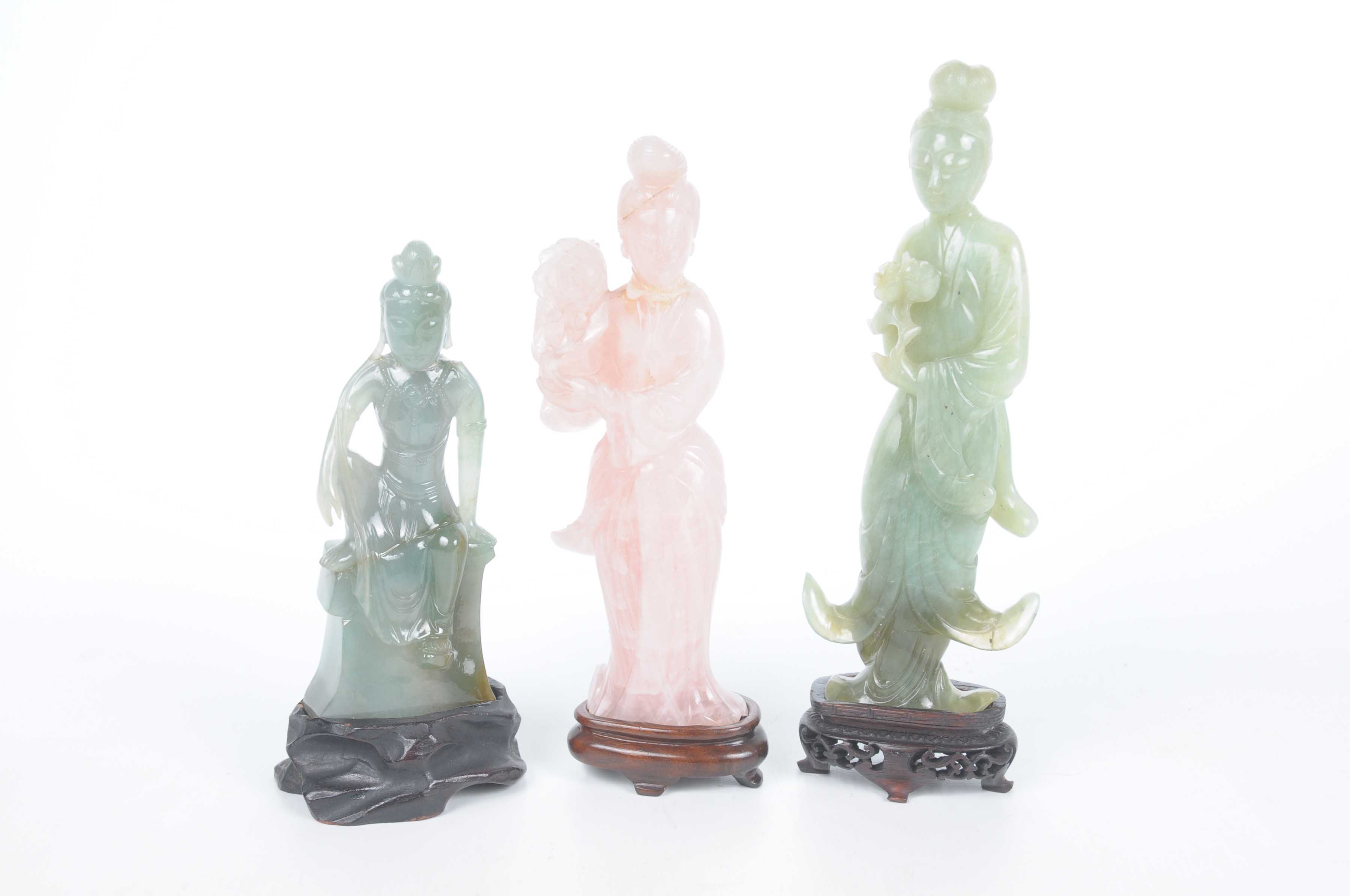 A collection of Chinese green hard stone and quartz figures of Guanyin The two green carved