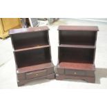 A pair of mahogany water fall bookcases With two graduated shelves above a plinth base with a