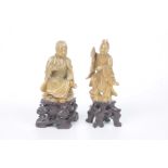 Two Chinese carved hardstone figures of immortal gods Each carved on a rocky outcrop,