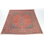 An Afghan style rug The vibrant red ground set within a flowerhead,