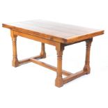 A good quality reproduction honey oak draw leaf refectory dining table With a rectangular cleated