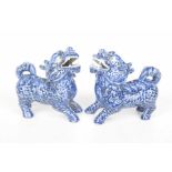 A pair of Chinese blue and white Shishi figures Each modelled in standing position with snarling