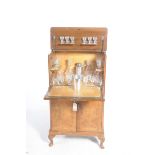 A mid 20th Century burr walnut drinks cabinet The rectangular hinged top with a gadroon border