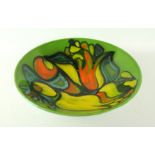 A large Poole pottery Delphis bowl Having multi-coloured stylised decoration on a green ground,