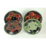 Four Moorcroft pottery circular cake stands One example decorated in the "Pansy" pattern and three