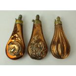 Three copper and brass powder flasks mid 19th Century First of fluted form,